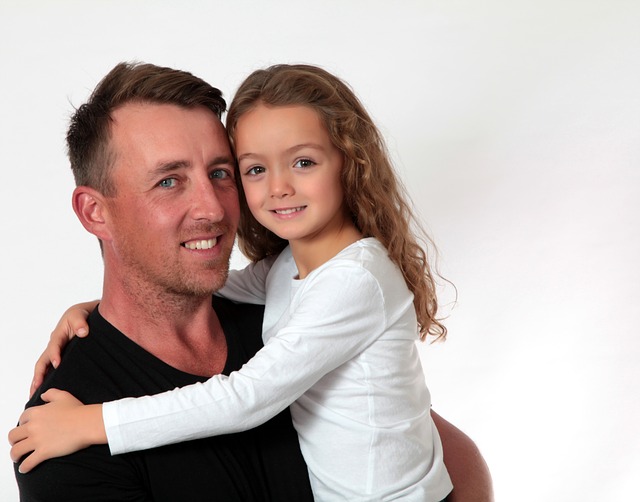 father with 6 yo daughter in arms